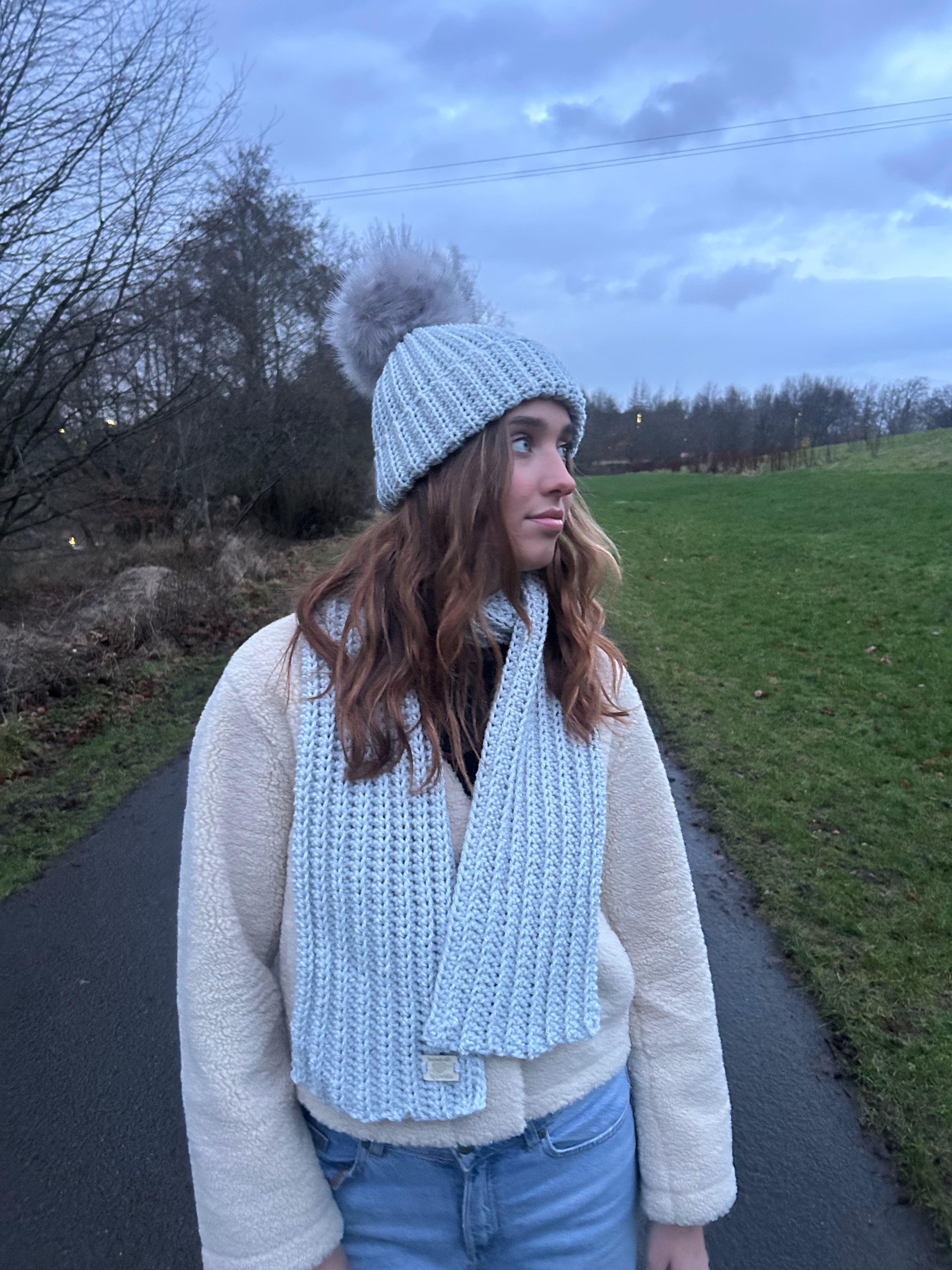 Cream crochet beanie with faux-fur pom-pom